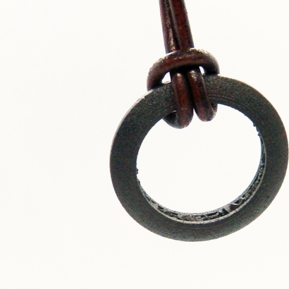 Ring shaped pendant with a raw band inside